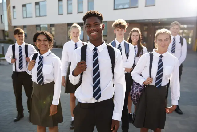 Smiling high school learners in uniform